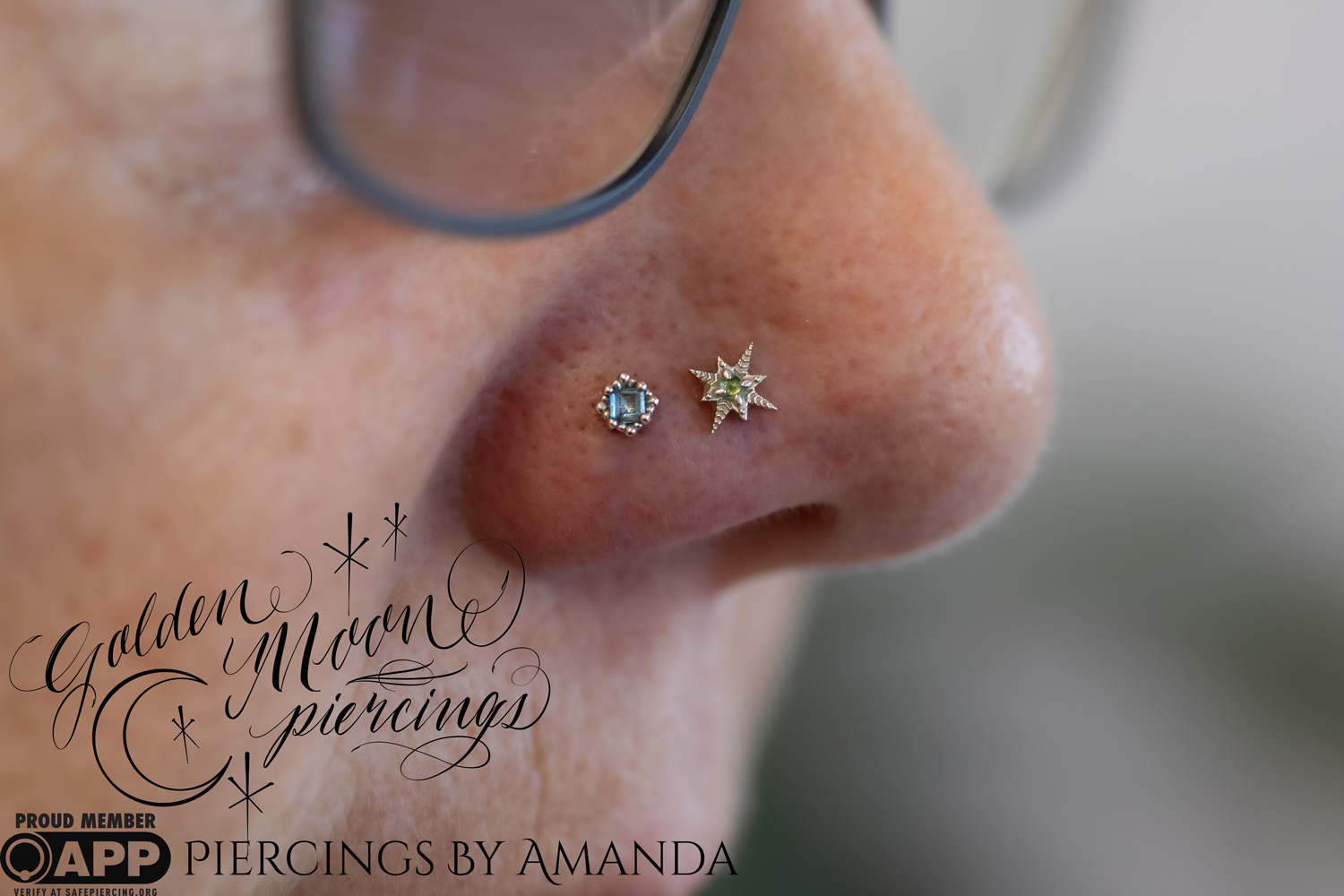 Two nostril piercings (one fresh, one healed) Amanda did with 14k white gold, London Blue Topaz, and Emerald